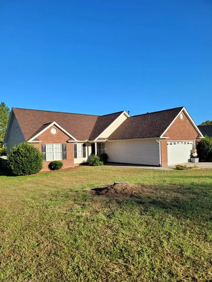Brick ranch home with a new shingle roof